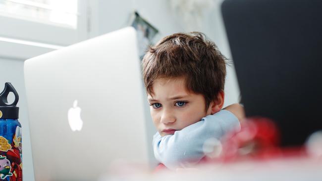 Phoenix Crawford does school work on a laptop at home in Sydney this month. Picture: Getty Images