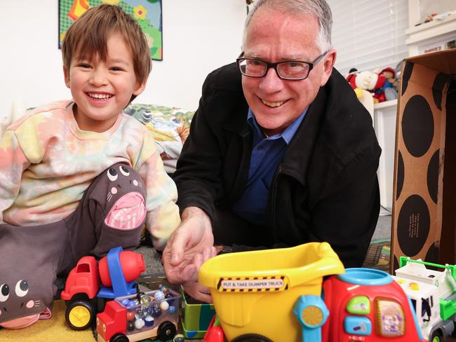 Professor Keith Hill has reduced his work hours to spend more time with family including three-year-old grandson Clancy. Picture: David Caird