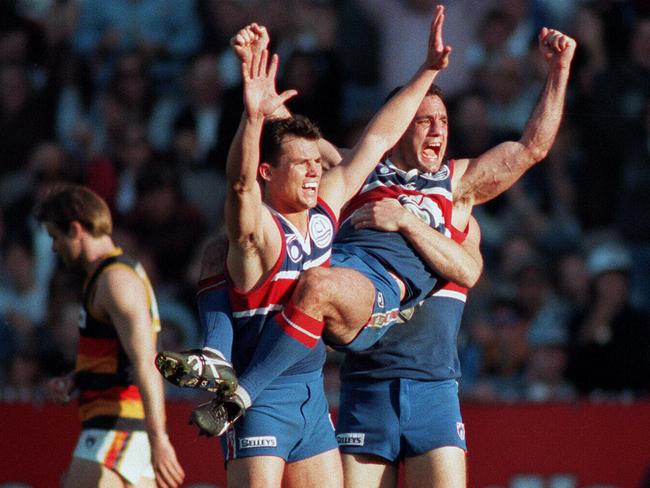 Brent Montgomery, Tony Liberatore and Paul Hudson celebrate what they think is the matchwinning goal in the 1997 preliminary final against Adelaide.