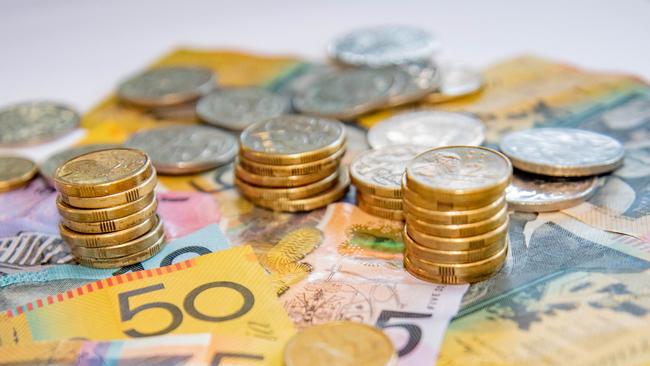 Australian notes and coins spilled out on a table, money cash generic