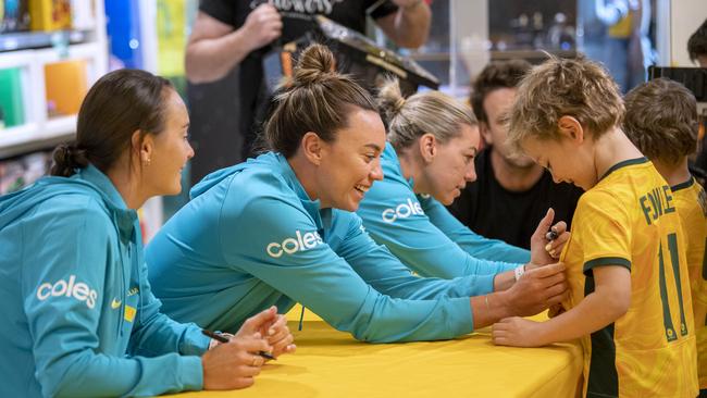 Fans line-up for signatures during a meet and greet with Matilda's players Caitlin Foord, Mackenzie Arnold and Alanna Kennedy. Picture Mark Brake