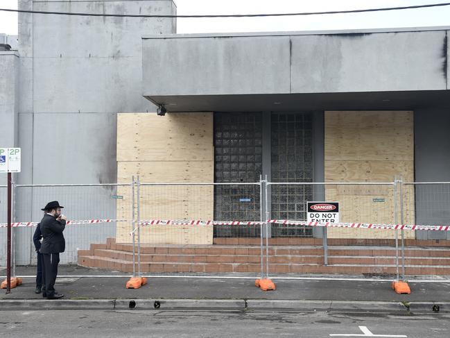 People inspect the damage to the synagogue. Picture: Andrew Henshaw