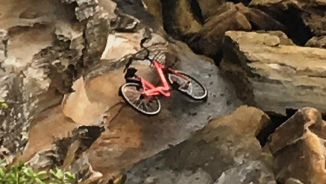 One of the rental bikes left on rocks at Malabar Beach.