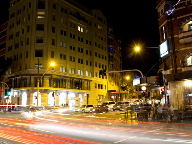 A night view of a Sydney city pub and busy street.