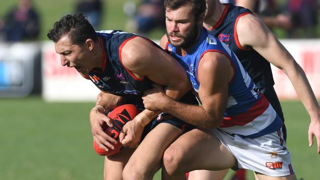 Norwood’s Patrick Levicki tackled by Central’s Justin Hoskin. Picture: Tricia Watkinson