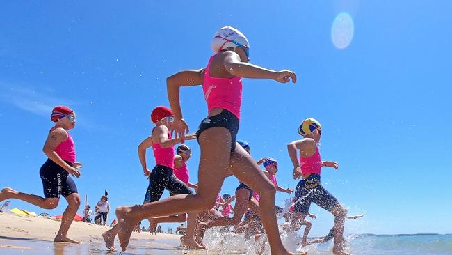 Competitors hit the water during the final of the under-10 Female Surf Race at the NSW Surf Life Saving Championships at Blacksmiths Beach on Friday, 28 February, 2020. Picture: Troy Snook