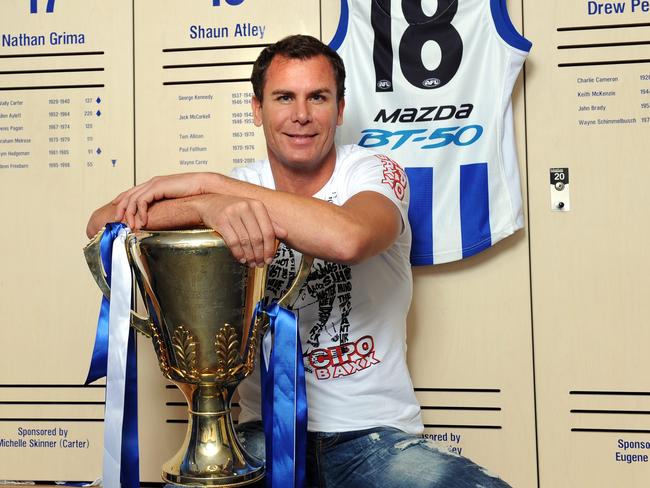 North Melbourne legend Wayne Carey back at Arden St. Premiership cup.