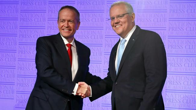 Australia's Labor leader Bill Shorten (L) and Liberal leader and prime minister, Scott Morrison, shake hands at the start of "The Leaders' Debate" at the National Press Club of Australia in Canberra on May 8, 2019. - Last week's poll showed the election will be closely fought, but also underscored the complexities of Australia's election system -- which asks voters to rank parties by preferences and encourages voting pacts between major and minor parties. (Photo by Liam KIDSTON / POOL / AFP)