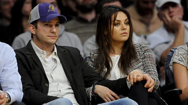 The newly engaged actors Ashton Kutcher and Mila Kunis attend an NBA basketball game betw