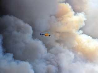 CONCERN BUT NO PANIC: A huge bushfire impacts Peregian Springs and Coolum residents as the flames threaten their homes. The fire burnt over 500 hectares and dozens of emergency crews were deployed throughout the night. An Observation helicopter.