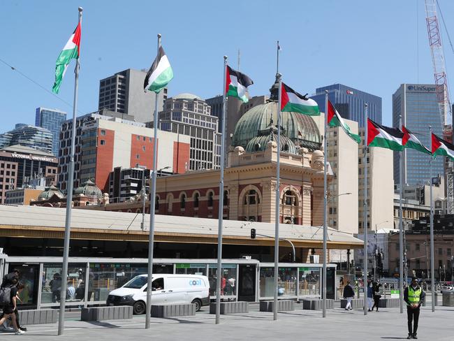 Palestinian flags fly at Federation Sqaure. Picture: David Crosling