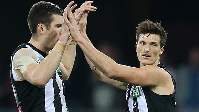 Collingwood players celebrate a goal against the Suns. Picture: Getty Images