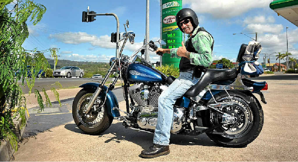 FILL ‘ER UP: Alan Samels of Nambour is pleased to have scored one of the cheapest fuel prices on the Sunshine Coast for his Harley-Davidson motorcycle at the BP on Currie St, Nambour, where fuel prices are much cheaper than on the rest of the Sunshine Coast. Picture: Iain Curry