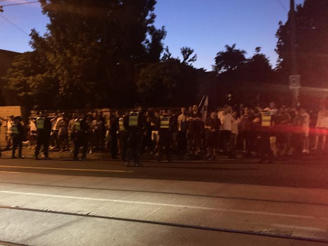 Police monitor crowds outside a Caulfield South synagogue.