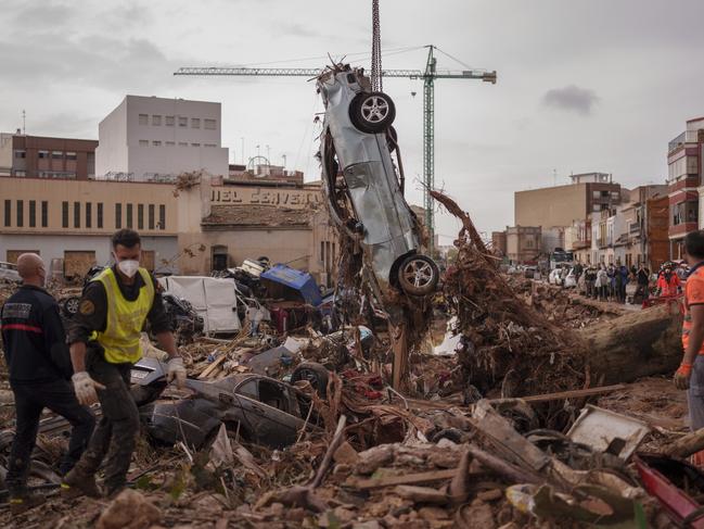 Emergency services remove cars in an area affected by floods in Catarroja, Spain. Picture: AP