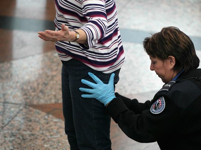 A traveler undergoes an enhanced pat down by a Transportation Security Administration agent at the Denver International Airport in Denver, Colorado 22/11/2010. The TSA is bracing for heavy traffic before the Thanksgiving holiday as two separate internet campaigns are promoting a 'National Opt-Out Day' protest during which travelers are urged to refuse the new body scanners because of concerns over privacy and possible exposure to radiation. Those passengers who refuse the scans must instead undergo an enhanced pat down by TSA agents, which could further slow down security lines on the busiest air travel day of the year.