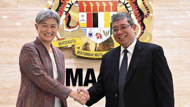 Malaysia's Foreign Minister Saifuddin Abdullah (R) shaking hands with Penny Wong upon her arrival in Putrajaya. Picture: Supplied