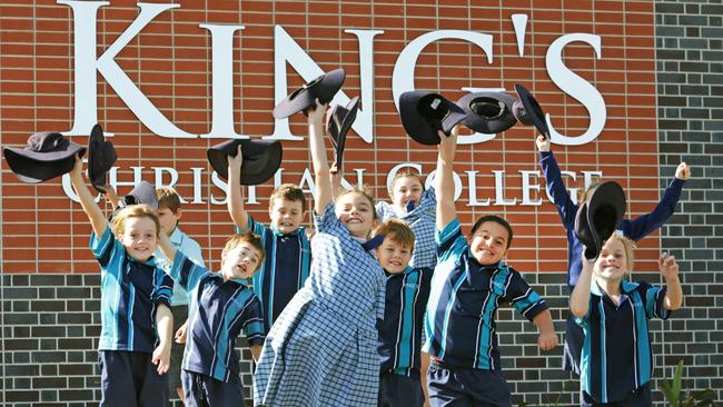 Minister Kate Jones will officially open the King's College northern campus at Pimpama the school has years prep- 3, and each year will add an extra grade. Year 3's Ayla Garaty (front) and her classmates celebrate the opening. Pics Tim Marsden