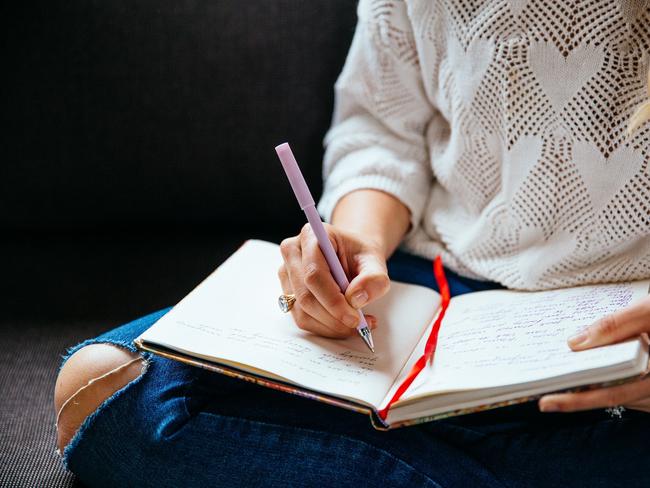 Michelle Menzies. Writing in her journal. For TasWeekend. Supplied.