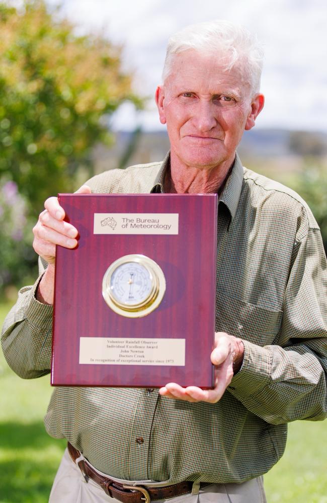 Beef farmer John Newton with his award, recognising his 50 years of service recording crucial weather data for the Bureau of Meteorology.