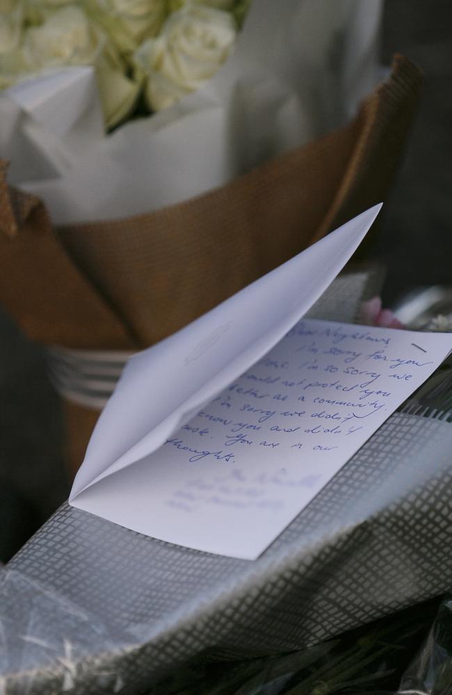 A card of condolence left with flowers by a resident of the West Pennant Hills neighbourhood.