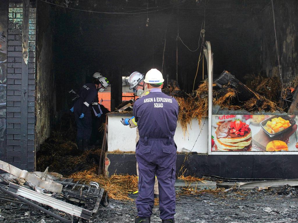 Forensic police in front of a firebombed store in Campbellfield on May 7. Picture: Luis Enrique Ascui