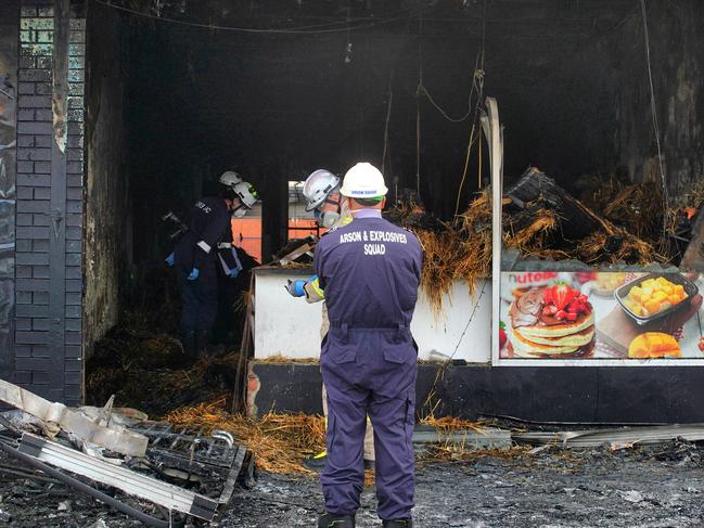 Forensic police in front of a firebombed store in Campbellfield on May 7. Picture: Luis Enrique Ascui