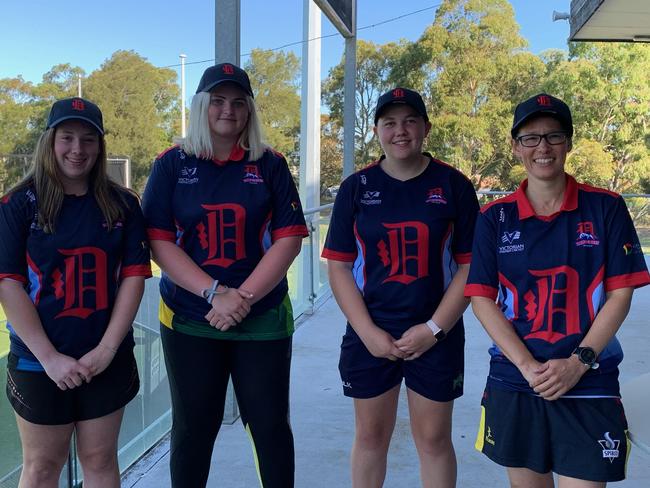 Dandenong players Lily-May Lyndon, Molly Harnett and Lillian Strong with coach Megan Pauwels.