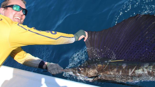 Angler Dale Egan with his first sailfish . PALMO SUN