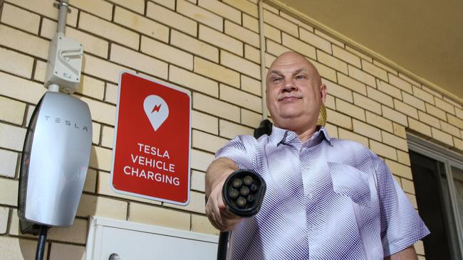 Nanango Star Motel owner Andrew Beck with newly installed Tesla vehicle charger. Photo: Dominic Elsome