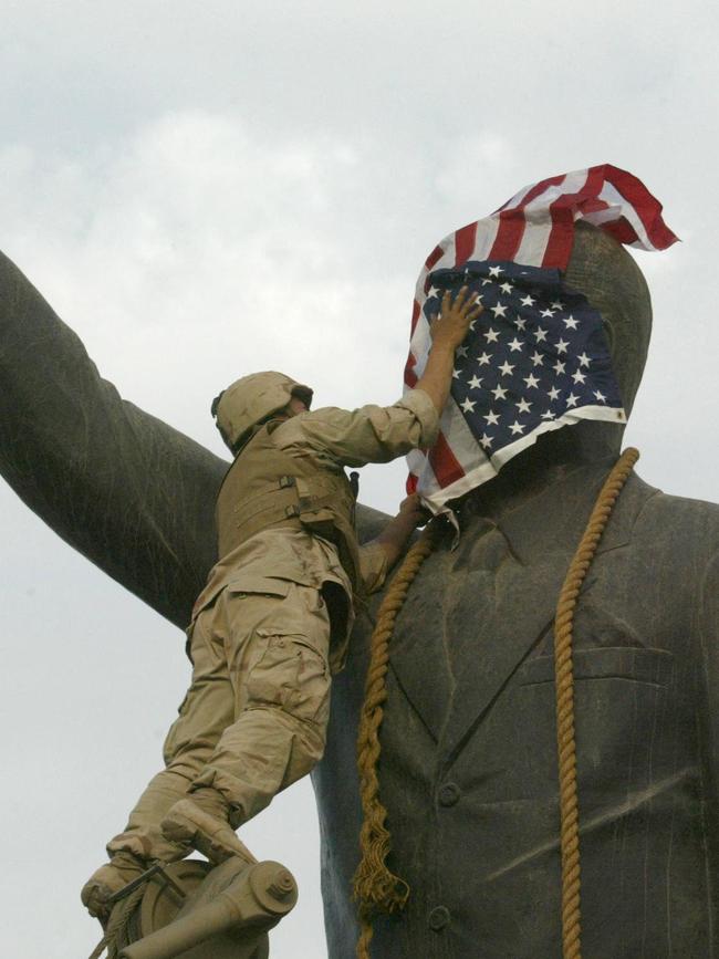 US Marine covers the face of Saddam Hussein's statue