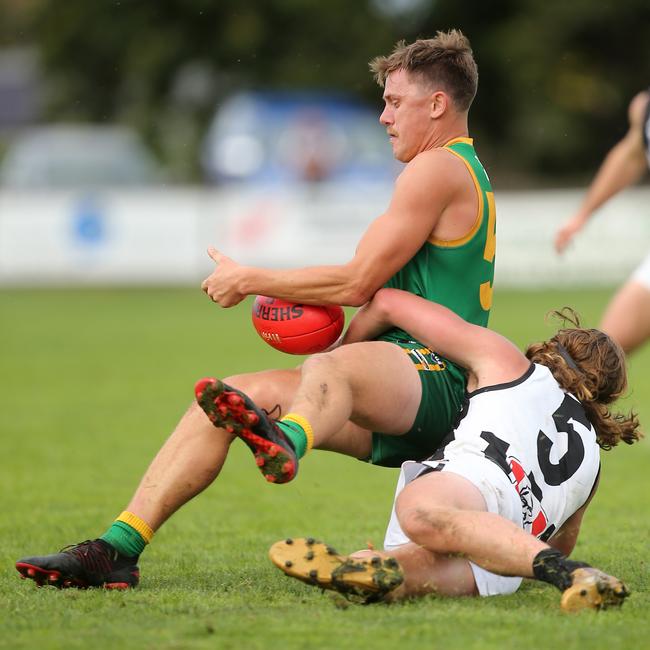 Leongatha’s Aaron Heppell is caught by Sale’s Jack McLaren. Picture: Yuri Kouzmin