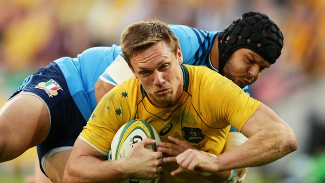 Dane Haylett-Petty of the Wallabies is tackled against Italy at Suncorp Stadium.