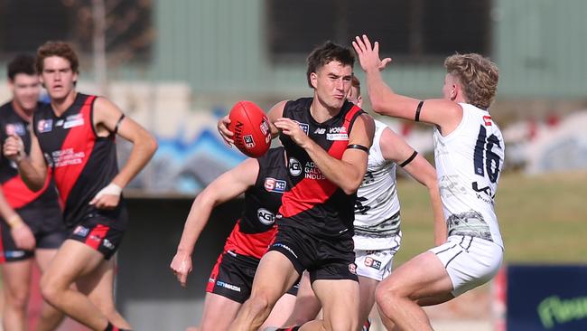 West’s Liam Delahunty confronted by South’s Elliot Duncin. Picture Dean Martin