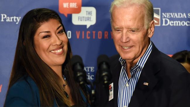 Lucy Flores and Joe Biden at the 2014 rally at which she claims he behaved in an inappropriate manner. Picture: AFP.