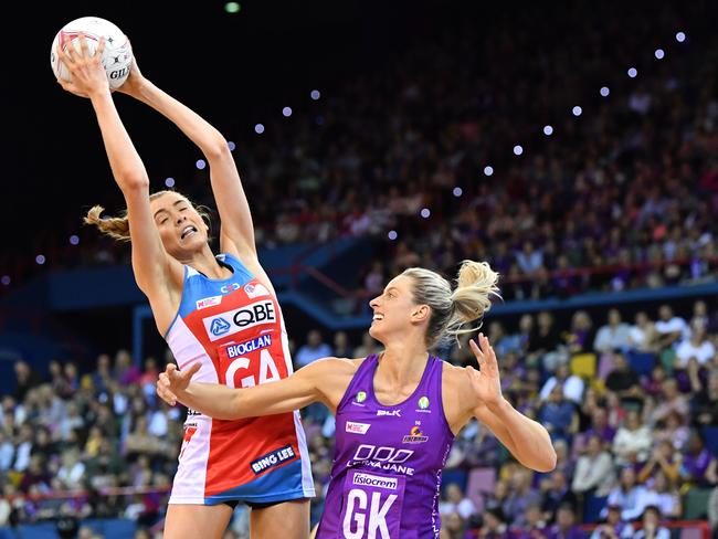 Helen Housby catches the ball over Laura Geitz during the Firebirds win in round eight.