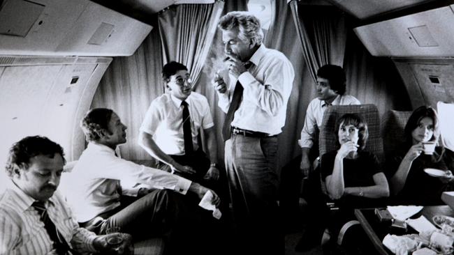 Bob Hawke lights a cigar on a VIP flight during the 1983 election campaign. New Labor leader Hawke goes on to defeat Malcolm Fraser. Picture: Ray Strange