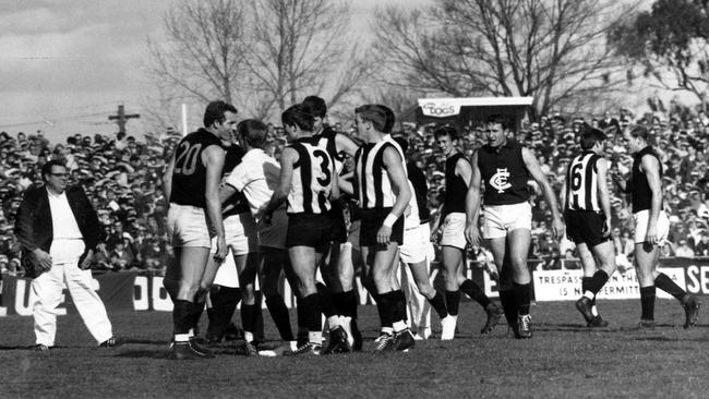 Tempers cool as boundary umpires and trainers part the scuffling players in a Collingwood v Carlton clash in 1966.