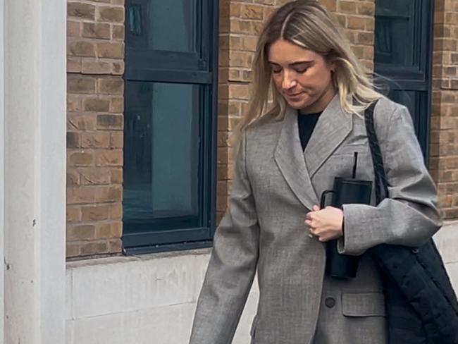 Kristie Mewis, the fiancee of Sam Kerr leaves court, clutching her coat to protect her growing baby bump. Photo: Sophie Elsworth.