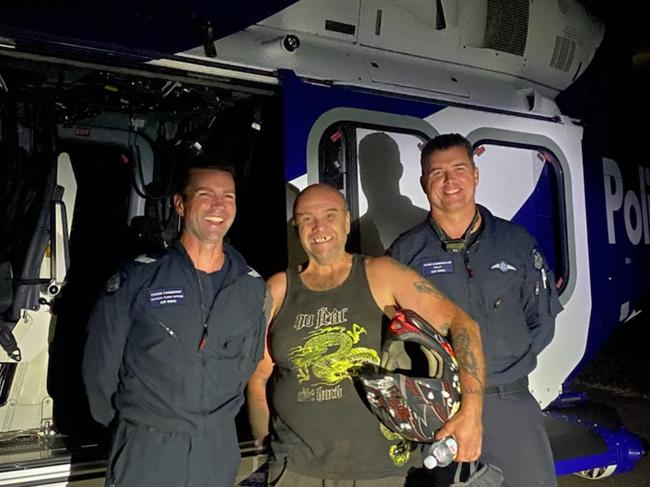 The police Air Wing has located a man who went missing while camping at Cambarville overnight.The 49-year-old went dirt bike riding with two friends when he became separated from his mates near Frenchmans Spur Track.He rode around trying to locate them or their campsite for several hours until he eventually ran out of fuel.With intermittent phone reception, he managed to get in contact with his friends but wasn’t able to make his way back to them.It was when he started to have a medical episode that he called Triple Zero (000) for assistance about 10.10pm.Using the Mitcham man’s GPS location on his phone, the police Air Wing was deployed to try and locate him.The camper lit a fire to attract the attention of the rescue helicopter, who spotted the man about 1.30am.The chopper was able to manoeuvre into a small clearing and rescue the man.He was taken to hospital to be treated for dehydration and observation.L to R Airwing Officers: Senior Constable Craig Carberry and Adam Chamberlain (Pilot) and camper Robert. Picture: Victoria Police