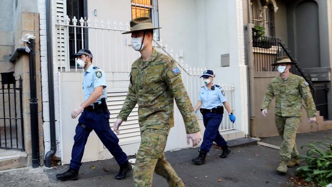 NSW police officers and members of the Australian Defence Force undertaking random self-isolation checks in Sydney. Source: NSWPF