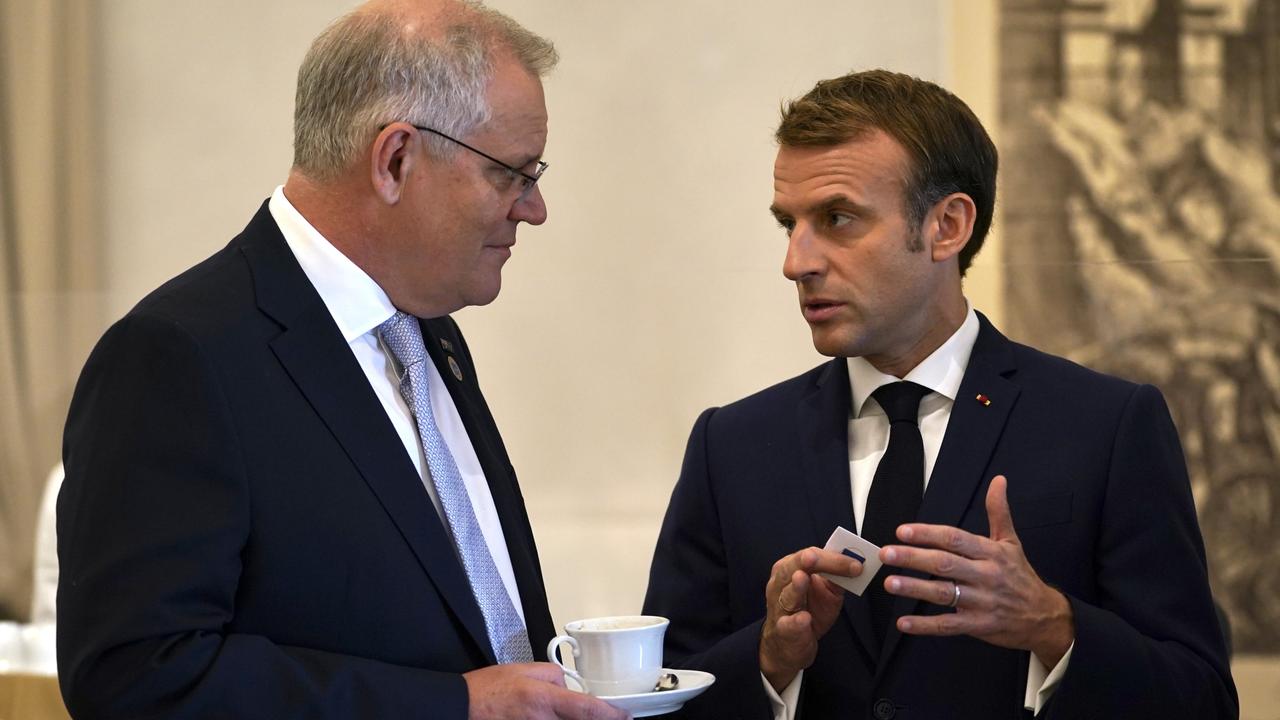 Prime Minister Scott Morrison and French President Emmanuel Macron talk before the G20 leaders make a short visit to the Fontana di Trevi. Picture: Adam Taylor