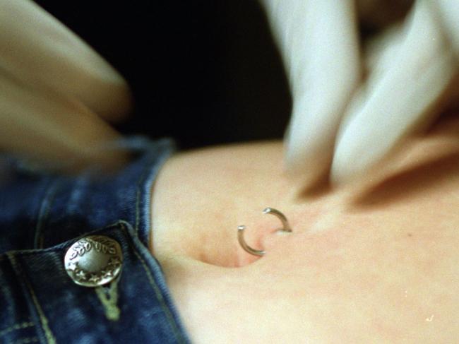 Matt Hird, body piercer and tattooist from Second Skin Tattooing threads the ring through and attaches the ball.  Picture: Fiona Harding WEEKENDER SPREAD Matt Hird, body piercer and tattooist from Second Skin Tattooing threads the ring through and attaches the ball.  Picture: Fiona Harding