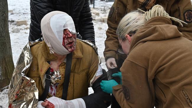 Medical staff provide assistance to a resident injured as a result of a missile attack in Kharkiv on January 23. Picture: AFP