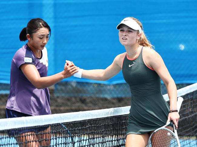 Kyoka Okamura is congratulated by Emerson Jones at the conclusion of their International Tennis Federation (ITF) Cairns Tennis International quarter final match at the Cairns International Tennis Centre. Picture: Brendan Radke