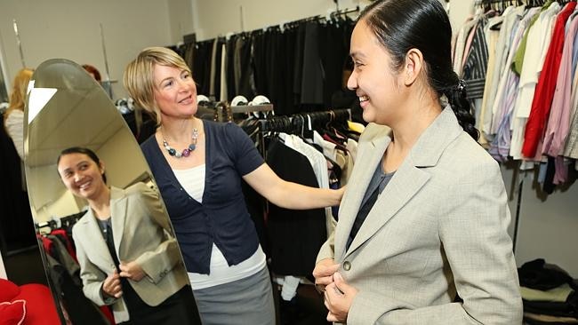 Mentor Angela Donald, from the Fitted For Work program, helps Jenny Tapao with her corporate attire. 