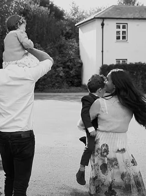 The pair carry their children up the driveway to Frogmore Cottage in a scene from their Netflix docuseries. Picture: Netflix