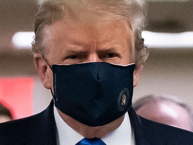 (FILES) In this file photo taken on July 11, 2020 US President Donald Trump wears a mask as he visits Walter Reed National Military Medical Center in Bethesda, Maryland. - US President Donald Trump said early on October 2, 2020 that he and First Lady Melania had tested positive for the coronavirus. (Photo by ALEX EDELMAN / AFP)