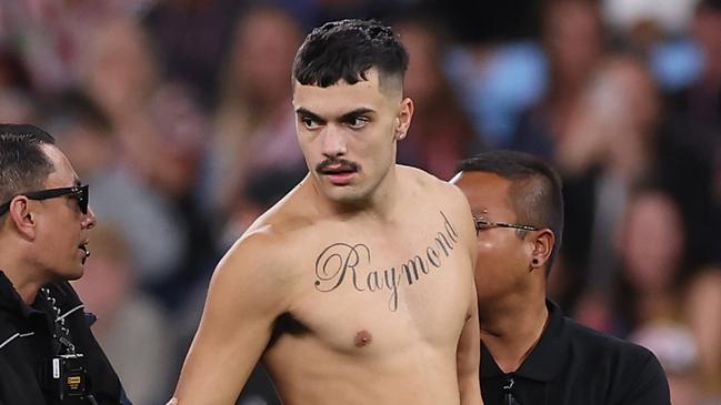 SYDNEY, AUSTRALIA - APRIL 25:  A pitch invader is taken off the field by security during the round eight NRL match between Sydney Roosters and St George Illawarra Dragons at Allianz Stadium on April 25, 2023 in Sydney, Australia. (Photo by Mark Kolbe/Getty Images)