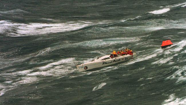 Injured crew of dismasted yacht Stand Aside waiting to be rescued in Bass Strait during Sydney Hobart race in 1998.